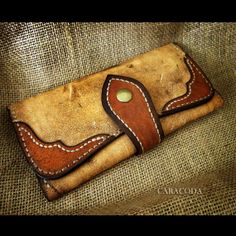 an old leather wallet sitting on top of a couch