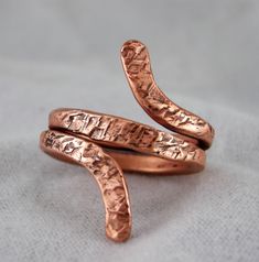 I have been asked to make copper rings over the years. I came across some copper wire when I stopped for a visit at my Great Uncles farm. This copper came from the lighting rod and is well over 100 years old. Handmade so each ring will very. Hammered Satin finish, very comfortable style. Like all Copper Rings These WILL Discolor your skin, most times turning the skin green or dark Washing will remove the discoloration . Sizes 6, 8, 8.5, 8.75, 9, 10, 10.5, 11, Mens Copper Ring, Vintage Copper Ring Jewelry, Copper Wire Rings, Handmade Elegant Copper Rings, Unique Silver Copper Ring, Unique Silver-colored Copper Ring, Copper Wedding Band, Wide Silver Band, Pattern Ring