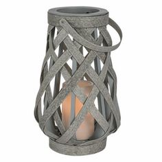 a gray candle holder with an intricate design on the front and sides, made out of wood