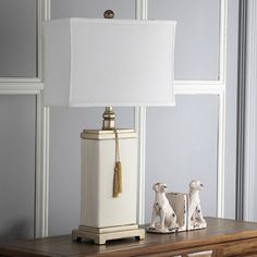 An elegant box shape and white shade define this Safavieh table lamp. In cream/white. Tassel accent adds a unique look. Three-way switch which allows you to adjust the brightness. 29 1/2H x 16 1/2W x 9D Requires one 100-watt CFL bulb (not included) Shade: cotton Base: ceramic Assembly required Model no. LIT4000A Size: Furniture. Color: Brown. Gender: unisex. Age Group: adult. Tassel Lamp, Small Living Room Decorating Ideas, Cream Table Lamps, Hall Lights, Modern Home Office Design, Flower Pillows, Flower Chair, City Bedroom, Mirrored Table