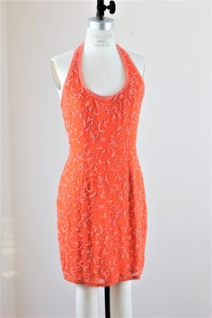 "Party time!! Can you wear orange?? Not all people can..but those who can..should!! This is a beautiful tangerine dress...with a halter top, absolutely darling!! Excellent condition Measuring: 35\" length Bust: 36\" Waist: 28\" Hip: 38\" Pet Free/smoke free Enjoy!" Sleeveless Orange Evening Dress For Wedding, Glamorous Orange Sleeveless Dress, Orange Backless Party Dress, Summer Embellished Halter Neck Dress, Fitted Halter Neck Dress With Beaded Straps, Embellished Halter Neck Dress For Summer, Embellished Fitted Halter Dress For Evening, Embellished Halter Neck Evening Dress For Summer, Embellished Fitted Halter Dress For Cocktail