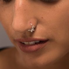 a woman with a nose piercing on her nose