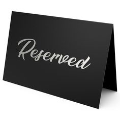 a black sign with the word reserved written on it