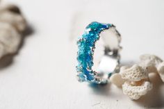 Beautiful ring Wave will bring you back to the sea! This ring is unique! Using hot enamel technique every item receives his own unique texture! https://www.etsy.com/listing/559371911/ - Wide wave ring (10 mm) Details: Width: 5mm Thickness: 1.2 mm Materials: sterling silver 925, hot vitreous enamel These rings in gold: https://www.etsy.com/listing/932462309/ - Gold blue wave https://www.etsy.com/listing/932465221/ - Gold green wave Please provide me size of the ring during the order, thank you! T Ocean-inspired Promise Ring, Ocean-inspired Blue Ring For Gift, Ocean-inspired Blue Ring For Gifts, Ocean-inspired Blue Rings As Gifts, Ocean-inspired Round Ring For Anniversary, Ocean-inspired Blue Jewelry For Anniversary, Blue Ocean-inspired Jewelry For Anniversary, Unique Womens Wedding Rings, Wave Jewelry