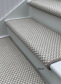 the stairs are lined with grey and white checkered carpet