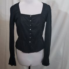 This Peasant Style Black Lucky Brand Long Sleeve Button Down Blouse Is New With Tags. Featuring Delicate Lace Trim Along The Neckline, Down The Front, And Along The Hem And A Square Neckline. Peplum Flounce At Bottom. Long Sleeves With Flare Detail At The Wrist. 100% Cotton, Machine Washable. Size Large, Approximately 20" Across Armpit To Armpit Laying Flat, Approximately 21.5" Long. Pairs Perfectly With Jeans Or A Flowy Skirt. Lightweight And Airy. Black Buttoned Blouse For Fall, Black Blouse With Buttons, Fitted Peasant Top For Daywear In Fall, Fitted Peasant Top For Fall Daywear, Spring Black Blouse With Buttons, Gothic Black Blouse For Spring, Black Peasant Top For Fall, Fitted Black Peasant Top For Spring, Black Cotton Blouse With Buttons