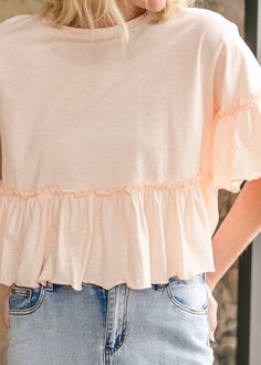 The Taytum Ruffle Sleeve Peplum Top is feminine and modest top that pairs perfectly with denim. Crafted from 100% cotton in a sunwashed peach hue perfect for this season. It has a feminine peplum silhouette with ruffle sleeves, and a modest crewneck. Just add denim and sneakers for a pretty everyday outfit. Style: Peplum, Short Sleeve Color: Peach SIZING TIPS Fit | Loose Fit Stretch | None Our Model wore True to Size. Soft-washed Tops For Spring Day Out, Soft-washed Pink Top For Spring, Spring Cotton Tops For Brunch, Chic Washed Summer Tops, Chic Washed Tops For Summer, Soft-washed Tops For Spring And Summer, Summer Light Wash Tops With Ruffles, Spring Washed Tops For Day Out, Summer Washed Tops For Day Out