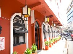 an orange building with potted plants on the outside