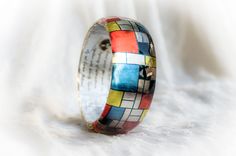 Mondrian Resin Bangle, Famous Art Jewelry, Resin Bracelet Mondrian Born 7 March 1872 - Died 1 February 1944 (aged 71) Middle design thick bangle - Height of the bangle - 3cm/1.18inches Pieter Cornelis Mondrian was a famous abstract Cubism painter, born in the Netherlands. His most recognized works are abstract paintings of colored squares, rectangles, and thick black lines.We love his minimal art , and that's why we decided to create a bracelet with his design in red, yellow, white and blue squa Multicolor Wearable Art Bangle Bracelets, Multicolor Wearable Art Bracelet, Multicolor Bangle Bracelets In Wearable Art Style, Multicolor Wearable Art Bracelet For Gift, Artistic Handmade Bangle Bracelets, Artistic Multicolor Cuff Bracelet Gift, Artistic Multicolor Cuff Bracelet As Gift, Artistic Multicolor Cuff Bracelet As A Gift, Hand Painted Multicolor Bangle Bracelet