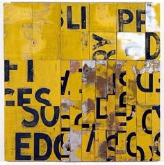 a collage of letters and numbers on yellow paper with black ink in the middle