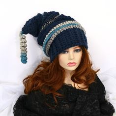 "Make winter fun with this chunky thick warm mountain ski snow hat. A little witchy, a bit of elf, and dark blue in color. I've crocheted this with bands of contrasting color and ridges. 21\" long from the top to the brim with a matching corkscrew tip, this hat is soft and can be shaped, tucked, or worn straight out. Certain to add character to your outdoor wear or gift to a friend who just loves fun things. Lots of stretch, so one size will fit most. Machine wash cold, lay flat to dry." Witchy Wide Brim Winter Costume Hat, Witchy Wide Brim Hat For Winter, Witchy Wide Brim Costume Hat For Winter, Witchy Brimmed Winter Costume Hats And Headpieces, Witchy Brimmed Winter Hats, Witchy Adjustable Winter Hats, Witchy Brimmed Costume Hat For Winter, Whimsical Winter Yarn Mini Hats, Whimsical Yarn Mini Hats For Winter