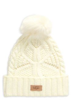 Complete your cold-weather style with this chunky cable-knit beanie topped with a faux-fur pompom. 54% acrylic, 42% polyamide, 4% wool with 60% modacrylic, 40% acrylic faux-fur pompom Hand wash, dry flat Imported Trendy Fluffy Winter Hats, Trendy Winter Faux Fur Hat, Fluffy Faux Fur Hat For Cold Weather, Winter Beanie With Pom Poms, Fur Pom Pom Beanie, Women's Headwear, Cold Weather Fashion, Fabric Gift Bags, Free Fabric