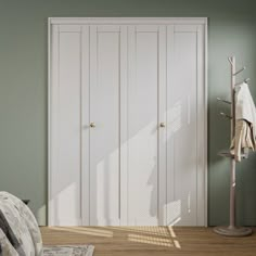 a bedroom with green walls and white closets