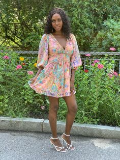 This Floral is dress is a summer must have. Take your style up a notch with this flawless floral open back dress. This dress is fully lined in a mini length featuring a plunging neckline, back neck button closure, and invisible back zipper. This flirty mini dress is perfect for any summer occasion. Dress it up with a statement heel or keep it casual with a summer sandal. Model is wearing a size small Fits true to size for most 100% Polyester Dress Length: 31 inches Flirty V-neck Floral Dress For The Beach, Flirty V-neck Mini Dress For Summer, Flirty V-neck Mini Dress For Day Out, Floral Print Sundress V-neck For Day Out, Flirty V-neck Sundress For Beach, Summer Party V-neck Dress, Chic Floral Print Mini Length Sundress, Chic Floral Print Mini Sundress, Chic Floral Print Sundress Mini Length