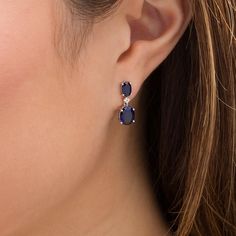 A timeless addition to her wardrobe, these fashion drop earrings are a style must-have. Crafted in sterling silver, each earring showcases an 8.0 x 6.0mm oval-shaped lab-created bright blue sapphire dangle suspended from a shimmering lab-created white sapphire. A 6.0 x 4.0mm oval-shaped created blue sapphire post completes this charming design. Buffed to a brilliant luster, these earrings secure comfortably with friction backs. Elegant Timeless Design Earrings As Gift, Elegant Earrings With Timeless Design As Gift, Elegant Gift Earrings With Timeless Design, Elegant Earrings With Timeless Design, Classic Sterling Silver Earrings With Timeless Design, Elegant Timeless Sterling Silver Jewelry, Elegant Sterling Silver Jewelry With Timeless Design, Elegant Earrings With Timeless Design For Everyday Luxury, Formal Earrings With Timeless Design