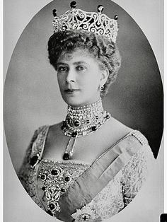 an old black and white photo of a woman wearing a tiara