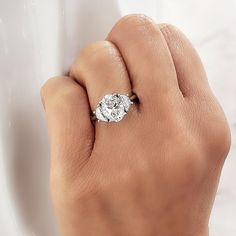 a woman's hand with a diamond ring on it