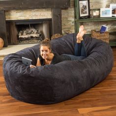 a woman laying in a large bean bag chair