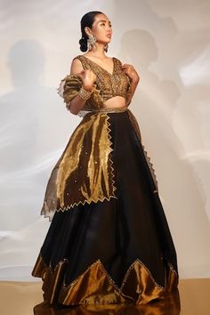 Black, gold attached cancan lehenga with cutdana, sequin embroidered border. Paired with sleeveless embroidered padded blouse and cutwork bordered dupatta. - Aza Fashions Silk Lehenga With Gold Embroidery For Party, Evening Organza Lehenga With Cutdana, Party Gold Raw Silk Choli, Silk Choli With Gold Embroidery For Party, Gold Organza Sharara For Party Wear, Gold Dupatta Sets For Evening, Gold Evening Set With Dupatta, Gold Sets For Evening Festivals, Gold Sharara With Zari Work For Evening