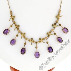 "You are looking at a rare antique collier necklace crafted in solid 14k yellow gold during the Victorian era. The center part of this beautiful necklace features elegant fringe designs alternating with clover leaf accents throughout. Each of these 7 dangle parts is set at its bottom with an old oval cut amethyst stone that shows amazing, rich purple color, and all 7 of them total approximately 14 carats in weight. The top of these fine gemstones, as well as the pretty leaf designs, are adorned Antique Round Purple Necklace, Fine Jewelry Oval Necklace For Collectors, Oval Fine Jewelry Necklace For Collectors, Antique Oval Purple Jewelry, Antique Amethyst Jewelry Stamped 14k, Antique Purple Oval Jewelry, Antique Oval Gemstone Necklace, Antique Hallmarked Purple Necklaces, Antique Purple Hallmarked Necklaces