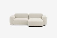 two white couches sitting next to each other in front of a white wall and floor