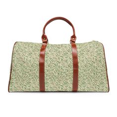 This William Morris travel bag is a perfect weekend bag for a quick getaway or overnight duffle. This luxurious bag is both stylish and functional. It is waterproof, spacious, easy to throw over your shoulder, and gorgeous. This vintage Morris design is of entwined willow leaves. It has been recolored and scaled to make it the ultimate traveler's luggage. If you appreciate maximalism, beautiful colors, sweeping leaves, and vibrant vintage floral patterns then this is the travel bag of your dream Green Rectangular Gym Bag For Overnight Trips, Rectangular Green Gym Bag For Overnight Trips, Green Duffle Bag With Luggage Sleeve For Travel, Beige Rectangular Duffle Bag With Luggage Sleeve, Rectangular Beige Duffle Bag With Luggage Sleeve, Beige Rectangular Luggage For Overnight Trips, Green Duffle Bag With Luggage Sleeve For Overnight Trips, Beige Rectangular Travel Bag With Luggage Sleeve, Green Travel Accessories With Luggage Sleeve For Overnight Trips