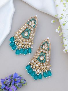 Unleash your inner diva with our teal blue  mesmerizing Indian Kundan Earrings. Designed to make a bold statement, these earrings exude captivating splendor, blending traditional Indian aesthetics with contemporary allure. Crafted with meticulous attention to detail, these earrings showcase the artistry of Kundan work. The vibrant Kundan stones take center stage, radiating a luminous charm that catches every eye. The intricate setting in gleaming golden tones adds an element of opulence and elevates their allure to new heights. Luxury Kundan Earrings With Peacock Design, Wedding Kundan Chandbalis With Peacock Design, Bohemian Green Bridal Earrings For Wedding, Bohemian Kundan Chandbali Chandelier Earrings, Turquoise Kundan Earrings For Wedding, Festive Kundan Danglers With Peacock Design, Festive Chandbali Chandelier Earrings With Peacock Design, Green Meenakari Chandelier Earrings For Diwali, Kundan Chandbali Danglers With Peacock Design