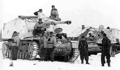 men standing next to tanks in the snow