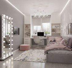 a bedroom with a bed, desk, mirror and lights on the wall above it