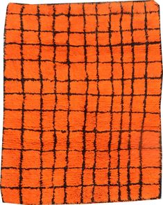 an orange rug with black squares on it