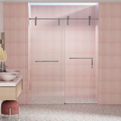 a bathroom with pink walls and tile flooring next to a walk - in shower