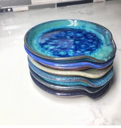 a stack of blue and white plates sitting on top of a counter