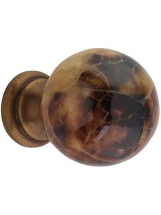 an antique style door knob with a brown marble finish