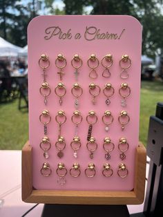 This unique display combines functionality with a chic aesthetic, making it the perfect addition to your permanent jewelry setup! Dimensions (without any base): 30 CHARM DISPLAY = approx. 6" x 8" 50 CHARM DISPLAY = approx. 8" x 8" 100 CHARM DISPLAY = approx. 10" x 11.75" --- PLEASE NOTE: Wooden stands are NOT offered with 100 charm displays! ---- Now featuring a sturdy wooden base and adorned with strategically placed rivets, adding an edgy yet refined flair. The rivets not only serve as eye-cat Charm Display Ideas, Charm Bar Display, Jewelry Workshop Studio, Jewelry Pop Up Shop Display Ideas, Permanent Jewelry Display, Anthropologie Jewelry Display, Jewelry Vendor Display, Charm Display, Handmade Jewelry Display