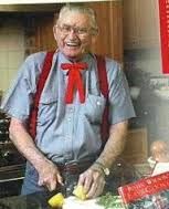 an old man in the kitchen making food