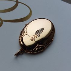 "Please note we offer layaway on all items which cost exceeds $100. Amazing Oval Art Nouveau locket with a cluster of little diamonds, and fine hand-carved engravings. At the back the feminine name \"Gunhild\" has been engraved. The original glass rhinestones have been replaced by genuine diamonds by a professional jeweler. On top of bringing more shine and sparkle to the antique locket, the diamonds are meant to last more than a lifetime. This locket is ready to be loved and cherished again for centuries to come :-) Details: The locket dates from the Art Nouveau era, 1890-1910. It is not stamped and I believe made of a gold plated metal. Condition: This locket has been refurbished by a professional jeweler. It has been polished and has now retrieved its original mirror-like luster. The rh Mirror Locket, Antique Engraved Jewelry For Anniversary, Gold Diamond Jewelry With Oval Cabochon, Heirloom Oval Engraved Jewelry, Traditional Gold Jewelry With Oval Cabochon, Antique Rose Gold Diamond Jewelry, Antique Diamond Jewelry For Ceremonial Occasions, Engraved Heirloom Oval Link Jewelry, Antique Oval Jewelry For Anniversary