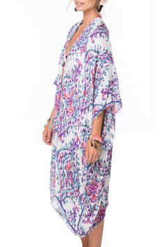 Bright, watercolor prints bring vivid contrast to this airy Kimono style from Pool to Party. Great paired with shorts or jeans or can be poolside ready. Vacay here we come. Modal/Viscose Luxury Blend One Size, Loose and Easy Shape Made in USA from fabric from India Chic V-neck Summer Kimono, Summer Patterned Kimono For Beach Cover-up, Patterned Kaftan For Summer Beach Cover-up, Printed Beach Dress For Spring Cover-up, Casual Patterned Kimono For Beach Cover-up, Bohemian Multicolor Printed Cover-up, Printed Beach Cover-up With Kimono Sleeves, Chic Spring Poolside Cover-up, Tropical V-neck Kimono For Summer