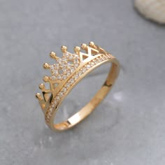 ★14K Solid Gold Crown Ring, 925 Sterling Silver Crown Ring, Princess Crown Ring, Queen Ring, Graduation Gift, Mother's Day Gift, Christmas Gift★ ▷ MATERIAL ★ All of our 10K, 14K, 18K Jewelry are Solid Gold. ( Not Gold Filled or Gold Plated ) ★ All of our silver jewelry is 925 sterling silver and 14 carat gold plated. (Our white silver jewelry is rhodium plated.) ▷ PRODUCTION AND PACKAGING ★ Our jewelry is handmade. It is specially prepared for you in the dimensions you want upon order. ★ We work with three colors in our jewelry. Yellow, Rose, White ★ We prepare our jewelry by examining it to the smallest detail with our 21 years of experience. ★ Since we care about customer satisfaction and long-term relationship, we produce our jewelry considering daily use and natural wear. ★ If you wish Queen Crown Ring Design, Crown Design Open Ring Jewelry Gift, Gold Cubic Zirconia Crown Ring, Promise Ring Jewelry With Crown Design And Open Shape, Crown Design Open Promise Ring, Crown Ring Queen, Crown Shaped Jewelry With Prong Setting As Gift, Gold Ring With Crown Design For Anniversary, Open Ring With Crown Design For Promise