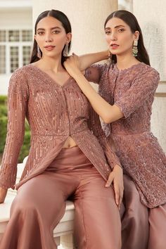 Taupe organza peplum kurta with tonal shiny dori embroidery in linear and scallop motifs. Comes with a bias cut gharara. Elegant Resham Embroidered Peplum Palazzo Set, Elegant Eid Palazzo Set With Peplum Top, Elegant Peplum Palazzo Set With Resham Embroidery, Elegant Peplum Palazzo Set For Diwali, Elegant Eid Peplum Set, Elegant Peplum Set For Eid, Elegant Peplum Sets With Mirror Work, Embellished Palazzo Set For Reception, Elegant Zari Work Peplum Palazzo Set