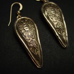 "Hand carved anglo saxon medieval kite shield museum earrings. Earrings design inspired by medieval Britain shields from the 12th century during the reign of the Anglo-Saxon and Vikings. A kite shield is a large, almond-shaped shield rounded at the top and curving down to a point or rounded point at the bottom. The term \"kite shield\" is a reference to the shield's unique shape, and is derived from its supposed similarity to a flying kite. - Hand sculpted and domed - Solid yellow bronze also ca Traditional Engraved Teardrop Earrings, Artisan Engraved Drop Earrings, Medieval Style Silver Earrings For Gift, Artisan Teardrop Pierced Earrings, Medieval Style Nickel-free Silver Earrings, Unique Hand Cast Drop Earrings, Handmade Bronze Ceremonial Earrings, Medieval Style Handmade Earrings For Gift, Handmade Bronze Earrings For Ceremonial Occasion