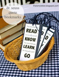 some books are sitting in a basket on a checkered tablecloth and there is a book that says read know learn go