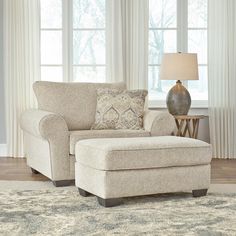 a living room scene with focus on the chair and ottoman