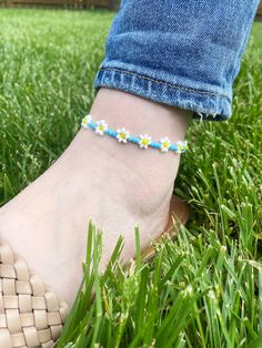 Blue Daisy Anklet Blue seed beads with white seed beads 3mm seed beads Anklet comes as shown* Sunflower Anklet sold separately  Other color options available, please select custom colors and add colors to personalized section.  Made from beads with durable elastic. Average ankle size is 9. Please select ankle size. CARING TIPS FOR YOUR JEWELRY ⭐️Treat and store with care. ⭐️ For longevity, avoid exposing your jewelry to water. ⭐️ Avoid having direct contact with lotions, perfumes, sanitizers as these chemicals may cause discoloration of your jewelry. Adjustable White Anklets For Spring, Spring Anklets With Colorful Beads, Casual Anklets With Ankle Strap For Gifts, Spring Flower Anklets, Flower Shaped Beaded Bracelets For Beach In Spring, Colorful Beaded Anklets For Spring Gift, Adjustable Anklets For Spring Gift, White Beaded Anklets For Summer, Spring Beach Beaded Bracelets With Flower Shape