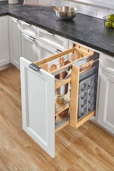 an open cabinet in the middle of a kitchen