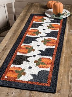 a table runner with pumpkins on it