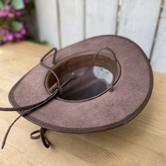 Rustic Adjustable Brown Top Hat, Distressed Brown Leather Brimmed Hat, Brown Hats With Leather Lining And Curved Brim, Brown Curved Brim Top Hat For Ranch, Brown Curved Brim Hat With Leather Lining, Brown Flat Brim Hat With Leather Lining, Classic Distressed Brown Hat With Short Brim, Vintage Brown Leather Brimmed Hat, Vintage Leather Fedora For Rodeo