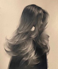 the back of a woman's head with long, wavy hair in black and white