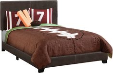 a football themed bed with pillows and blankets