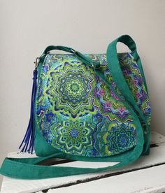 Green mandala bag, hippie bag, boho messenger bag, vegan crossbody bag, medium sized bag, festival bag, boho chic bag, sling crossbody bag -Medium sized messenger bag with adjustable strap -Simple style - Flap made from patterned fabric -Inside lining with two pocket -Bag closed by magnet -Bag made from eco suede Width 10,24- 11,81 in / 26- 30 cm height 9,84 in / 25 cm Care: wash in hands and lay flat to dry. Real colors may differ slightly from their appearance on your display. For more of my h Bohemian Crossbody Saddle Bag For Everyday Use, Green Crossbody Bag For Festival, Green Crossbody Shoulder Bag For Festivals, Bohemian Saddle Shoulder Bag For Travel, Green Bohemian Shoulder Bag For Everyday Use, Green Bohemian Shoulder Bag For Everyday, Bohemian Satchel With Adjustable Strap, Bohemian Crossbody Saddle Bag With Adjustable Strap, Bohemian Saddle Bag With Adjustable Strap