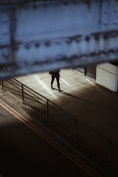 a person walking down the street at night